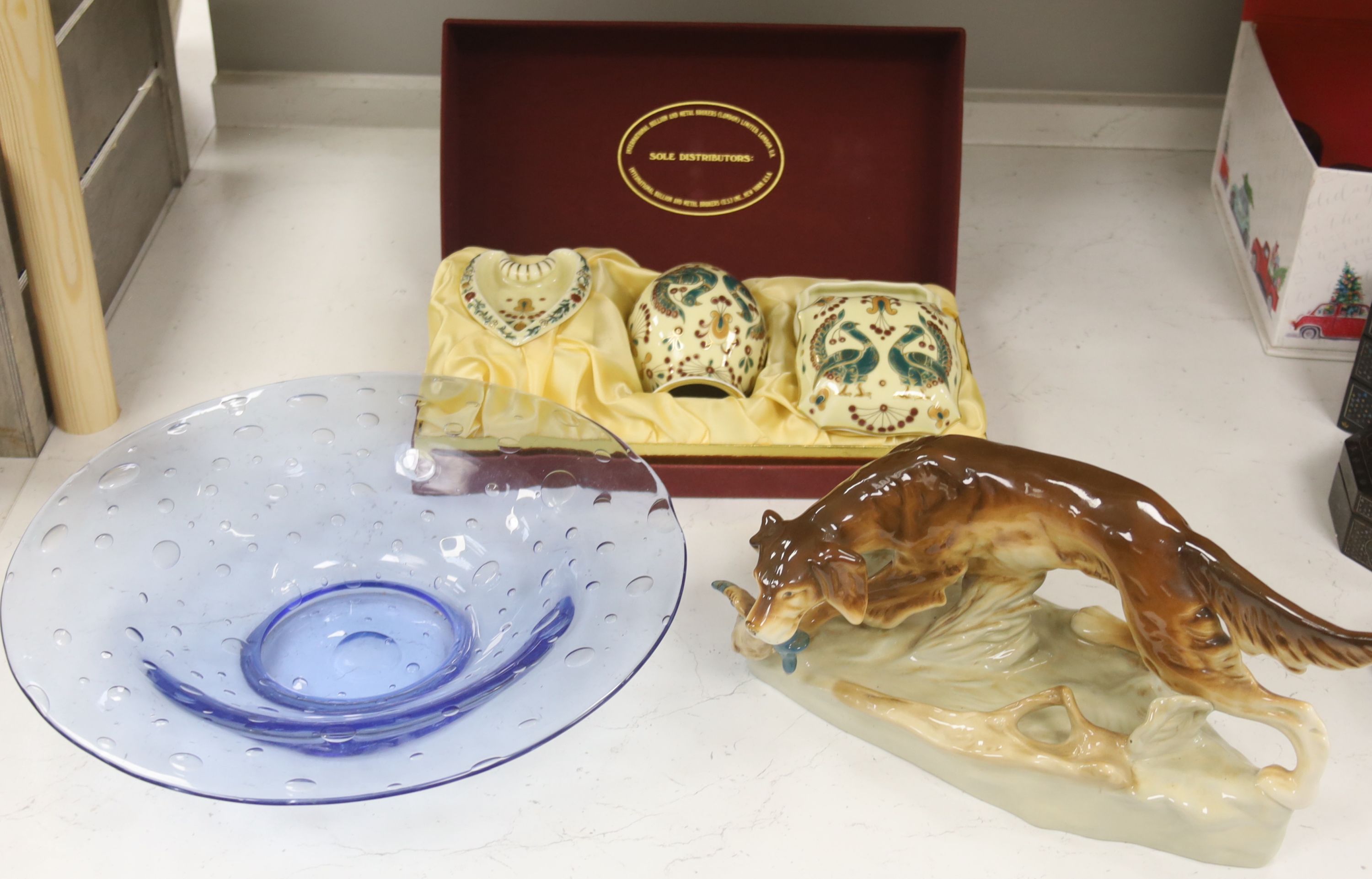 A large Czechoslovakian porcelain model of a hunting dog, length 33cm, together with a cased three piece Zsolnay Pecs presentation set and a hand blown Studio glass footed bowl, diameter 36cm
